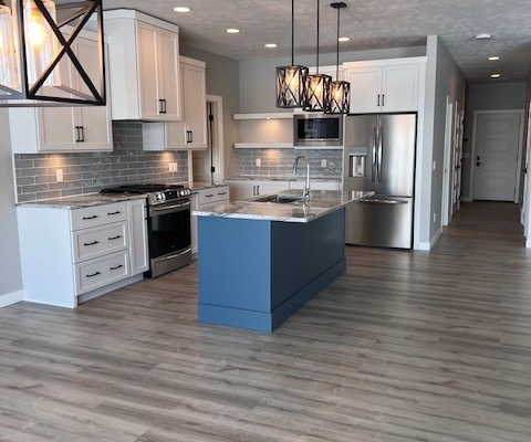 Custom Kitchen Blue Island Rosewood Homes Sioux Falls Custom kitchen with blue cabinetry island granite countertops and stainless appliances built by Rosewood Homes Sioux Falls